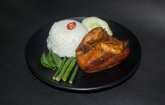 indonesian fried chicken with spicy sambal warm rice and vegetable also known as ayam lalapan