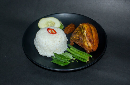 indonesian fried chicken with spicy sambal warm rice and vegetable also known as ayam lalapan