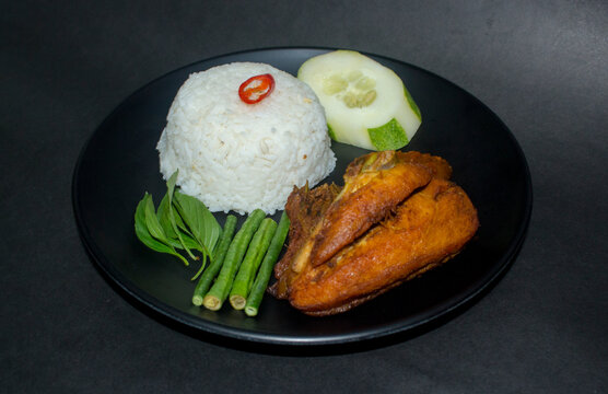 indonesian fried chicken with spicy sambal warm rice and vegetable also known as ayam lalapan