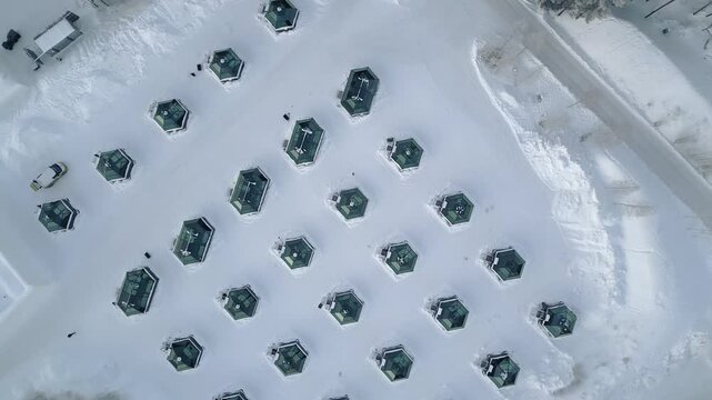 Aerial top down view luxury glass igloos snowy winter landscape unique accommodation luxury hospitality Arctic tourism concept