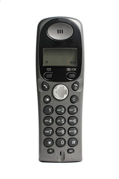 Vintage grey plastic cordless home phone receiver with buttons and small screen isolated white background