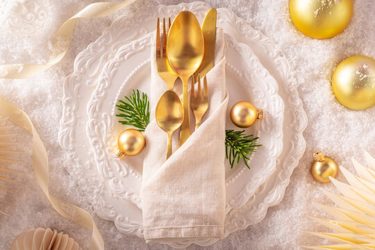 Flat Lay Golden Cutlery Place Setting in Snow
