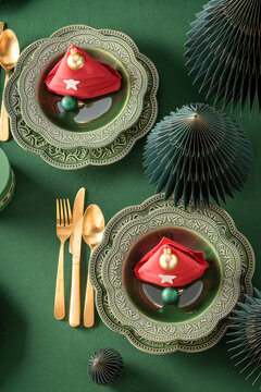 Top View of Green Christmas Table Setting with Red Napkins