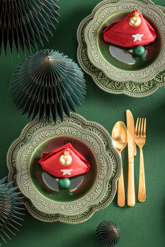 Elegant Green Christmas Table Settings with Red Napkins