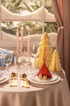 Cozy Christmas Dinner Table with Paper Trees and Candles