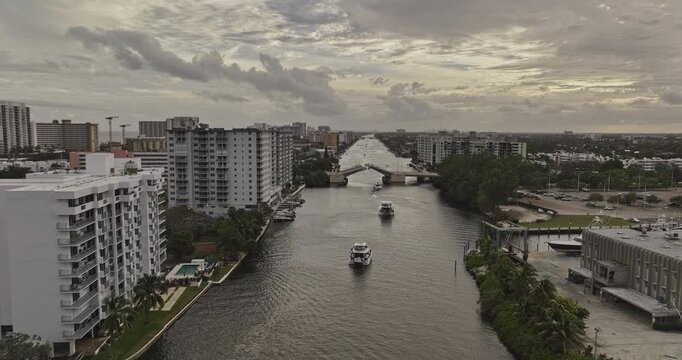 Pompano Beach Florida Aerial v3 low tracking flyover along the Intracoastal toward the NE 14th Street Causeway drawbridge and passing yacht - Shot with 5k Camera - Dec 10th 2023