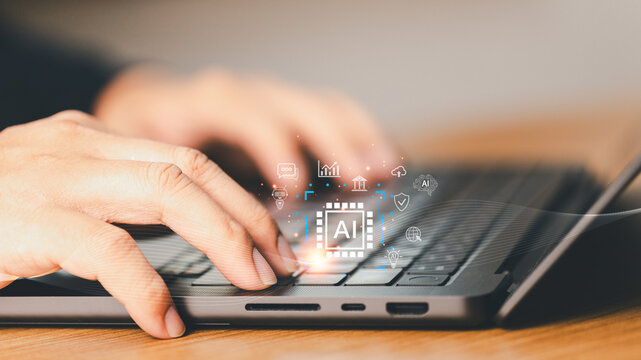 Close up hand of businessman using laptop with AI agent technology. Concept of artificial intelligence, digital innovation, machine learning and futuristic business technology
