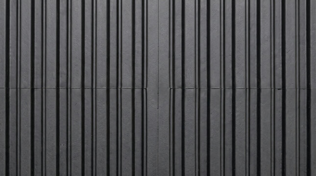 Black rubber elastomer sheet with vertical ribbed texture and parallel grooves forming a repeating industrial pattern for modern architectural surface background