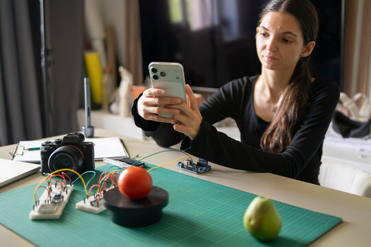 Woman Capturing Tomato Weight With Smartphone for AI Object Recognition Analysis