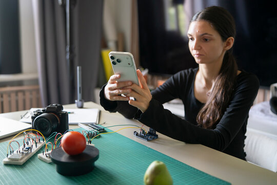 Close-Up of Woman Photographing Tomato on Scale Platform for AI Weight Analysis