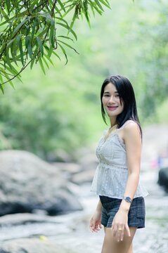 Beautiful Young Woman Swimming at Wang Takrai Waterfall in Thailand