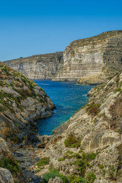Narrow Sea Inlet Between Rocky Hills and Stratified Cliffs in Gozo