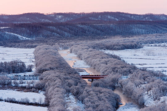 Bridge over river with frosted trees in winter landscape japan