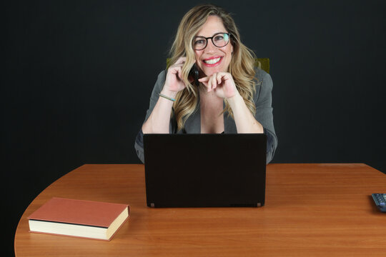 Professional Blonde Businesswoman Working with Laptop Computer at Office Desk