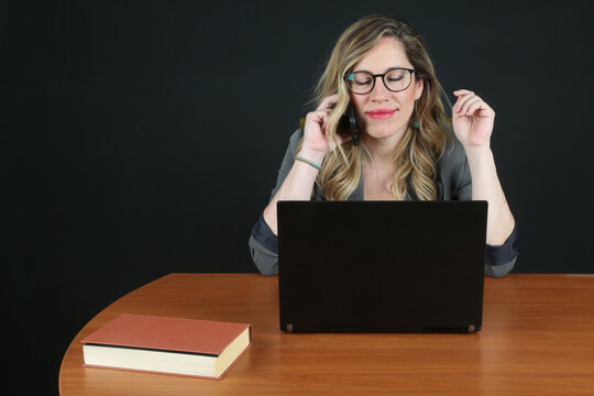Professional Blonde Businesswoman Working with Laptop Computer at Office Desk
