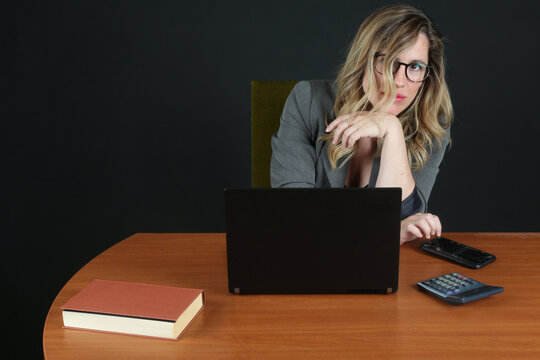 Professional Blonde Businesswoman Working with Laptop Computer at Office Desk