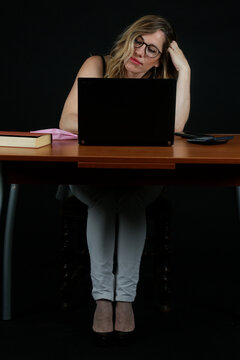 Professional Blonde Businesswoman Working with Laptop Computer at Office Desk