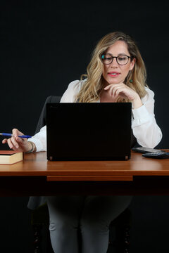 Professional Blonde Businesswoman Working with Laptop Computer at Office Desk