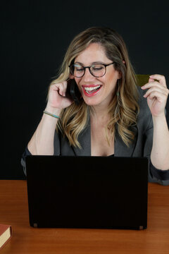 Professional Blonde Businesswoman Working with Laptop Computer at Office Desk
