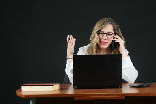 Professional Blonde Businesswoman Working with Laptop Computer at Office Desk