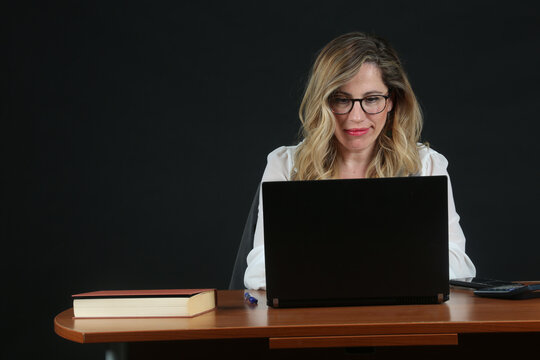 Professional Blonde Businesswoman Working with Laptop Computer at Office Desk