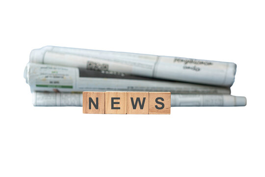 Wooden Blocks Spelling News With Rolled Newspapers. Isolated on transparent background.