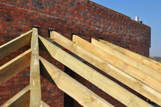 Roof rafters waterproofing on brick wall outdoors