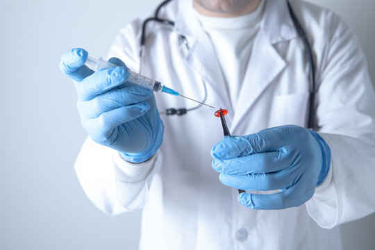 Doctor holding a syringe with a vaccine in his hands, close-up