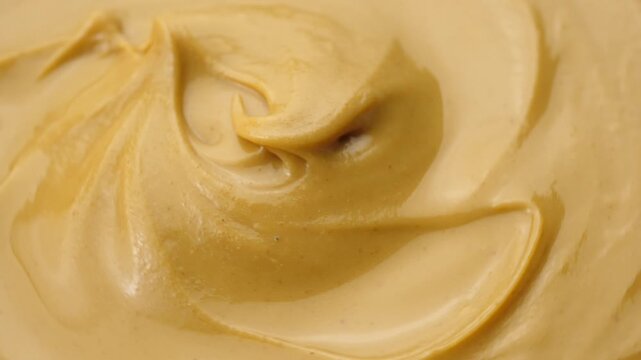 Creamy peanut butter top view.
Peanut butter is a delicious and nutritious food that offers several health benefits.