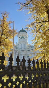 Helsinki Cathedral Behind an Ornate Iron Fence in Autumn Vertical