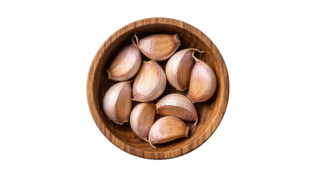 Fresh raw garlic cloves arranged in a round wooden bowl