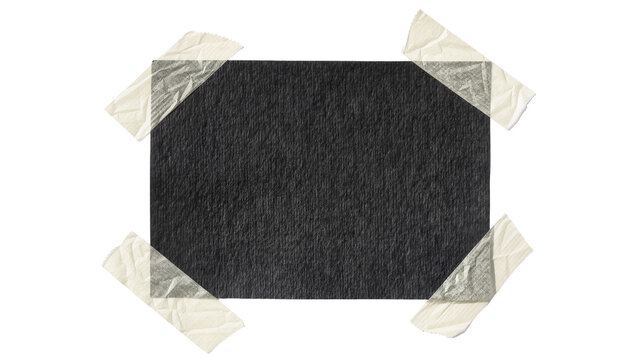 Black textured rectangle secured with four strips of masking tape, isolated on transparent background