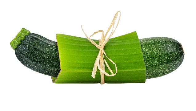 Fresh green zucchini wrapped in a banana leaf tied with natural raffia string