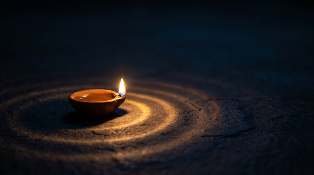 Golden Diya Flame Against a Dark Minimalist Background