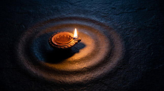 Traditional Diya Illuminating Darkness During Diwali