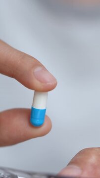 close up woman hand holding a medicine Anti-inflammatory. Stop drug use Taking Medication Caring for the health care medical concept.