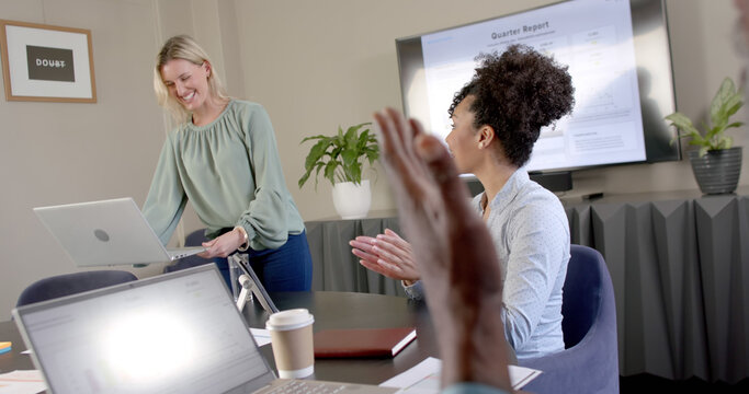 Diverse business people using laptops at conference table with copy space