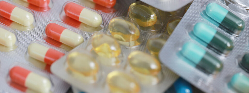 pills capsule on to surface tablets. drug medical healthcare pharmacy concept. pharmaceuticals antibiotics medicine in blister packs.	