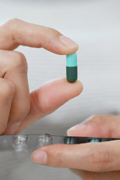close up woman hand holding a medicine Anti-inflammatory. Stop drug use Taking Medication Caring for the health care medical concept.
