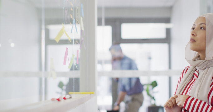 businesswoman using transparent board at office