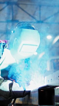 A skilled welder creating sparks and bright arcs of light while working on a metal structure, showcasing the artistry and precision in the field of welding.