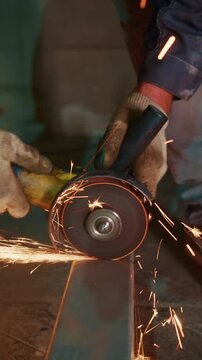 Worker Using Angle Grinder Cutting Metal, Sparks Flying, Close-Up Details of Tools and Safety Gear in an Industrial Setting