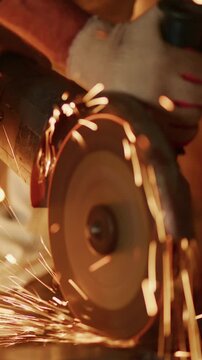 Close-Up of a Hand Operator Using a Circular Saw to Cut Metal, Sparks Flying, Showcasing Precision and Power in Craftsmanship and Metalworking Techniques