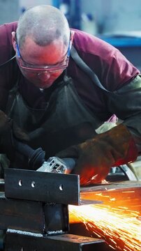 Craftsman Engaging in Precision Metal Work, Employing Tools to Shape and Finish Metal Components Under Utilized Workshop Lighting Conditions
