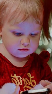 Captivating Child with Sparkling Blue Eyes Dressed in Festive Outfit Engaged in Playful Activity Surrounded by Holiday Cheer and Joyful Atmosphere
