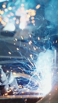 Dynamic Welding Sparks: Captivating Close-Up of a Metal Fabrication Process, Highlighting Vibrant Sparks and Electric Arcs in a Dark Environment