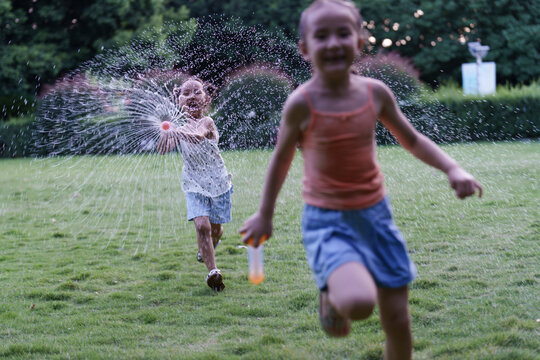 Chasing the Splash: Water Gun Chase on the Lawn