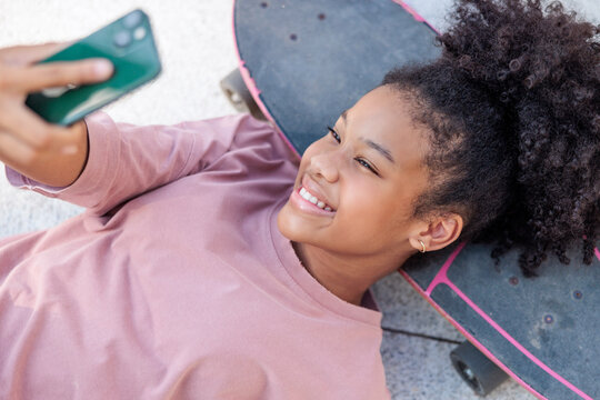 Teenage girl snaps selfies in a skate park