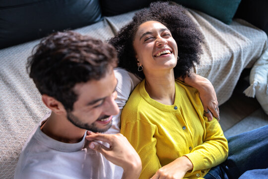 Man and woman sharing laughs at home