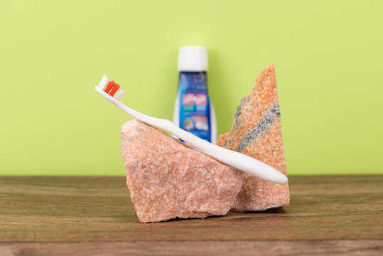 Toothbrush with granite stones  on a green background